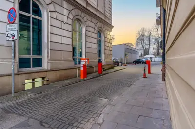 an empty street next to a building with orange cones at Świętej Gertrudy Chic Apartment by BookingHost in Kraków