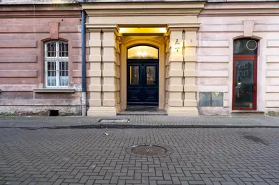 an entrance to a building with a black door at Świętej Gertrudy Chic Apartment by BookingHost in Kraków