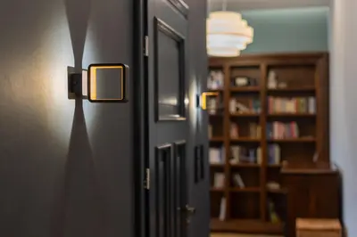a room with a door with a light on the wall at Świętej Gertrudy Chic Apartment by BookingHost in Kraków