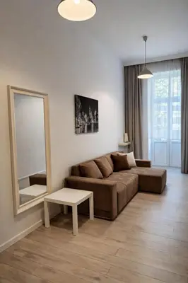 a living room with a couch and a mirror at Apartment with elevator in the heart of Krakow in Kraków
