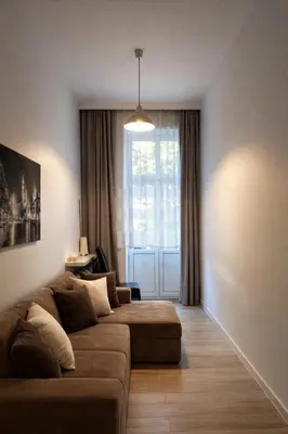 a living room with a couch and a window at Apartment with elevator in the heart of Krakow in Kraków
