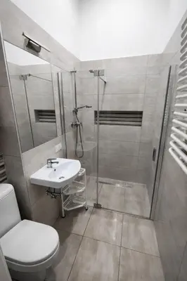 a bathroom with a shower and a toilet and a sink at Apartment with elevator in the heart of Krakow in Kraków