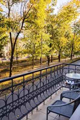 a row of tables and benches next to a fence at Apartment with elevator in the heart of Krakow in Kraków