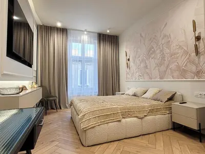 a bedroom with a large bed and a large painting on the wall at Apartament Krak Number One in Kraków