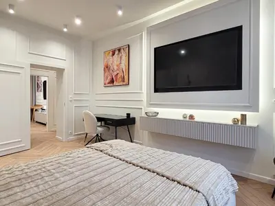 a bedroom with a flat screen tv on a wall at Apartament Krak Number One in Kraków