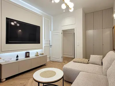 a living room with a couch and a flat screen tv at Apartament Krak Number One in Kraków