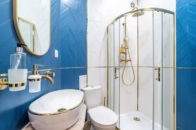a bathroom with a shower and a toilet and a sink at RentPlanet - Apartament Sobieskiego in Kraków