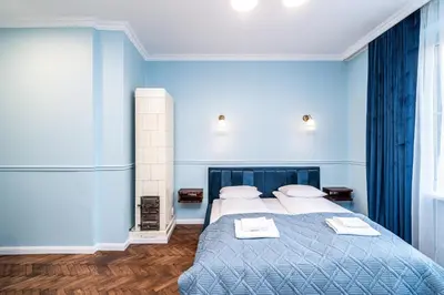 a blue bedroom with a bed with towels on it at RentPlanet - Apartament Sobieskiego in Kraków