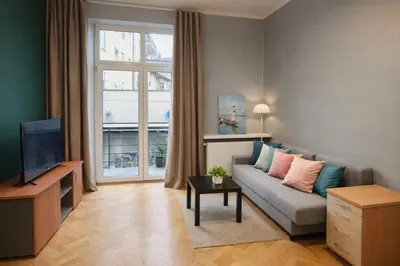 a living room with a couch and a television at Urban Nest Apartments Długa 82 in Kraków