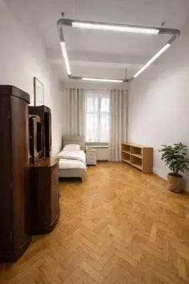 a large room with a bed and a tv in it at Urban Nest Apartments Długa 82 in Kraków