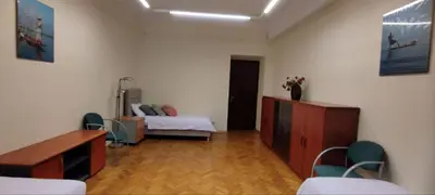 a room with a bedroom with a bed and chairs at Urban Nest Apartments Długa 82 in Kraków