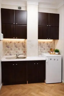 a kitchen with a sink and a white refrigerator at Urban Nest Apartments Długa 82 in Kraków