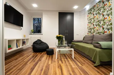 a living room with a couch and a table at Central Kazimierz Apartment in Kraków