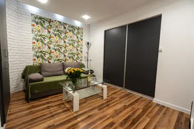 a living room with a couch and a glass table at Central Kazimierz Apartment in Kraków