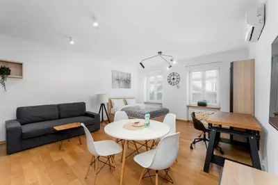 a living room with a couch and a table at Starowiślna 14 Downtown Studios by BookingHost in Kraków