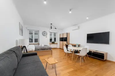 a living room with a couch and a table at Starowiślna 14 Downtown Studios by BookingHost in Kraków