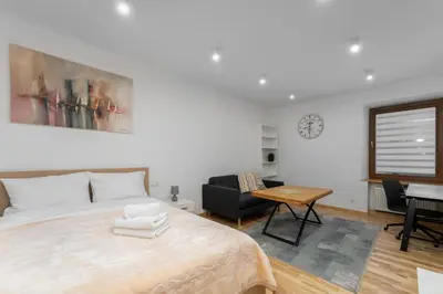 a bedroom with a bed and a table and a couch at Starowiślna 14 Downtown Studios by BookingHost in Kraków