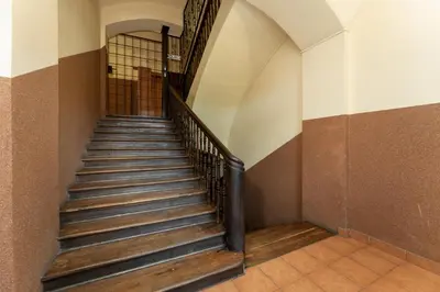 a staircase in an old building with wooden steps at Starowiślna 14 Downtown Studios by BookingHost in Kraków