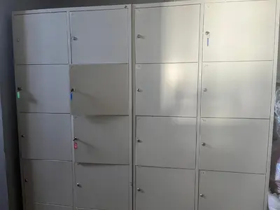 a row of white lockers in a room at 4Friends&4Couples in Kraków