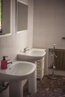 a white bathroom with two sinks and a shower at 4Friends&4Couples in Kraków