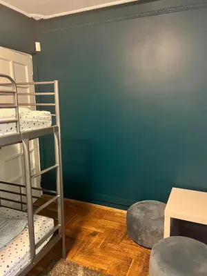 a room with two bunk beds and a green wall at 4Friends&4Couples in Kraków