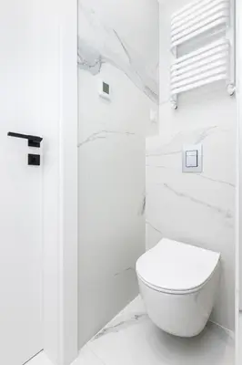 a white bathroom with a white toilet in it at Native Apartments Kościuszki 39I19 in Kraków