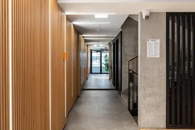 a corridor of a hallway with wooden walls and a long hallway at Native Apartments Kościuszki 39I19 in Kraków