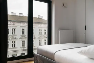 a bedroom with a bed and a large window at Native Apartments Kościuszki 39I19 in Kraków