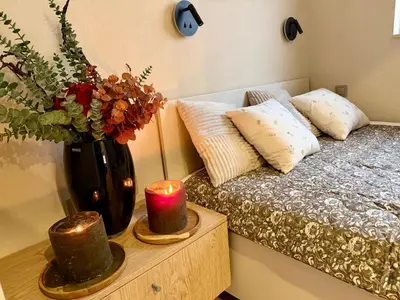 a bedroom with a bed and a vase with a candle at Way2Stay Kazimierz in Kraków