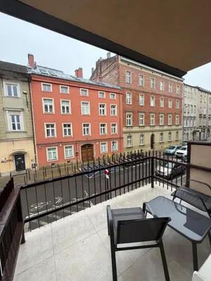 a balcony with chairs and a view of buildings at Way2Stay Kazimierz in Kraków