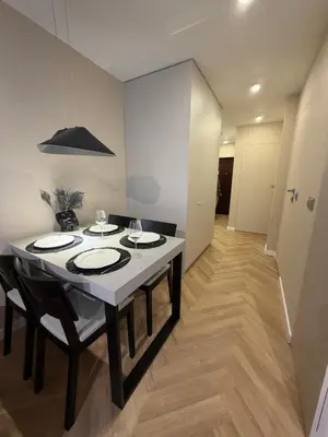 a dining room with a table with plates on it at Way2Stay Kazimierz in Kraków