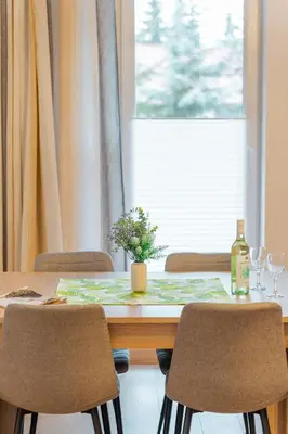 a dining room table with chairs and a table with a plant on it at Kraków Huculska Apt - Balcony, Workspace - by Rentujemy in Kraków