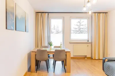 a dining room with a table and chairs at Kraków Huculska Apt - Balcony, Workspace - by Rentujemy in Kraków