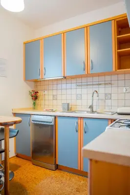 a kitchen with blue cabinets and a sink at Kraków Huculska Apt - Balcony, Workspace - by Rentujemy in Kraków