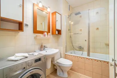 a bathroom with a washing machine and a sink at Kraków Huculska Apt - Balcony, Workspace - by Rentujemy in Kraków