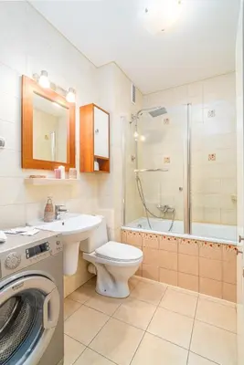 a bathroom with a toilet sink and a washing machine at Kraków Huculska Apt - Balcony, Workspace - by Rentujemy in Kraków