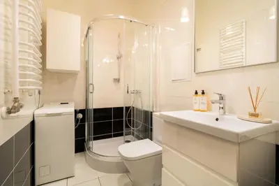 a bathroom with a shower and a toilet and a sink at Malila Premium Apartments Cracow Traugutta in Kraków