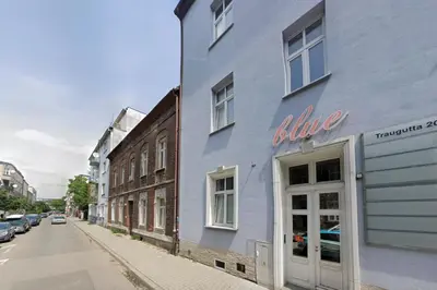 a blue building on the side of a street at Malila Premium Apartments Cracow Traugutta in Kraków