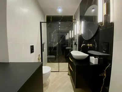 a black and white bathroom with a toilet and a sink at Apartament przy Rakowickiej II Old Town in Kraków