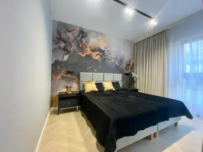 a bedroom with a large bed with a black blanket at Apartament przy Rakowickiej II Old Town in Kraków