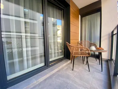 a patio with a table and chairs on a balcony at Apartament przy Rakowickiej II Old Town in Kraków