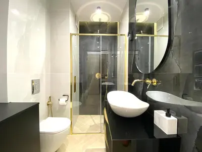 a bathroom with a sink and a toilet and a shower at Apartament przy Rakowickiej III Old Town in Kraków