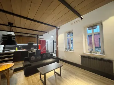 a living room with a couch and a table at Wawrzynca paradise - loft in the Kazimierz district in Kraków