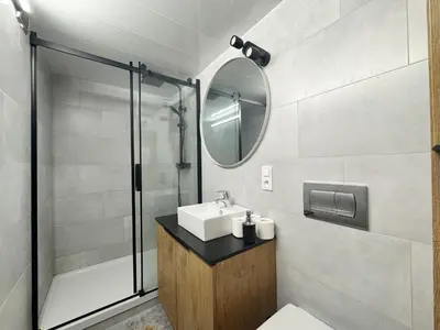 a bathroom with a sink and a mirror at Wawrzynca paradise - loft in the Kazimierz district in Kraków
