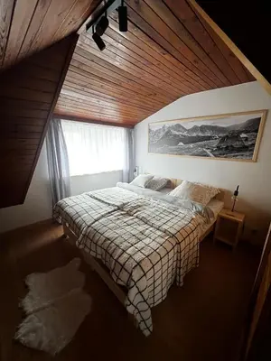 a bedroom with a bed with a wooden ceiling at Apartament 
