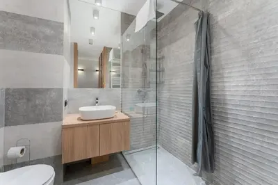 a bathroom with a sink and a shower at Siewna Homely Apartment in Kraków