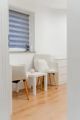a room with two chairs and a table and a window at Podgórze 2-Bedrooms Apartment - 54m2, Air Con - by Rentujemy in Kraków