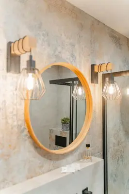a bathroom with a round mirror and a sink at Podgórze 2-Bedrooms Apartment - 54m2, Air Con - by Rentujemy in Kraków