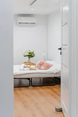 a room with a bed with a vase on a table at Podgórze 2-Bedrooms Apartment - 54m2, Air Con - by Rentujemy in Kraków