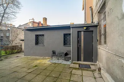 a house with a door and two chairs in front of it at Podgórze 2-Bedrooms Apartment - 54m2, Air Con - by Rentujemy in Kraków